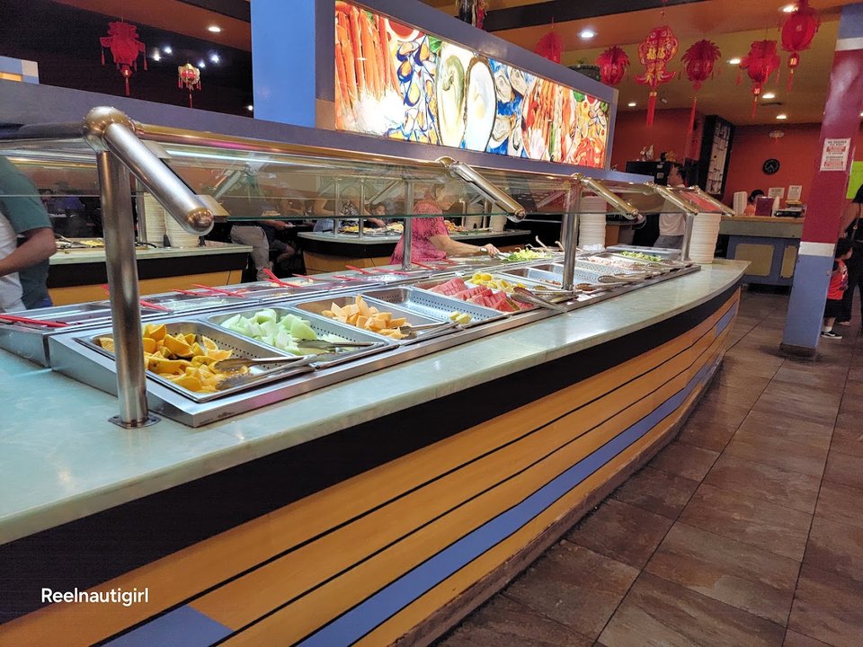 Buffet trays with sushi and Chinese dishes